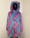 A hooded faux fur coat with a pink and blue tie-dye pattern, displayed on a black mannequin against a plain off-white wall.