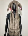 A gray faux fur hood with long bunny ears on the hood, displayed on a black mannequin against a plain light background.
