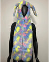 A faux fur festival hood with bunny ears, shown on a black mannequin against a plain light gray background. The vest has a pastel tie-dye pattern with blue, pink, yellow, and purple tones.