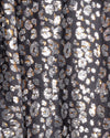 Close-up detail shot of metallic silver and gold sequin kimono fabric.