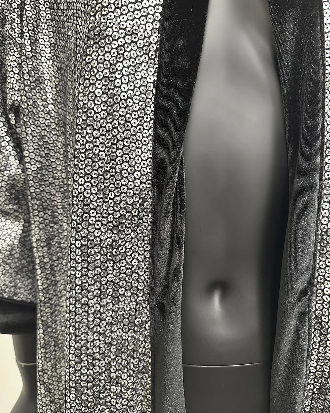 Mannequin wearing a patterned garment with a neutral background