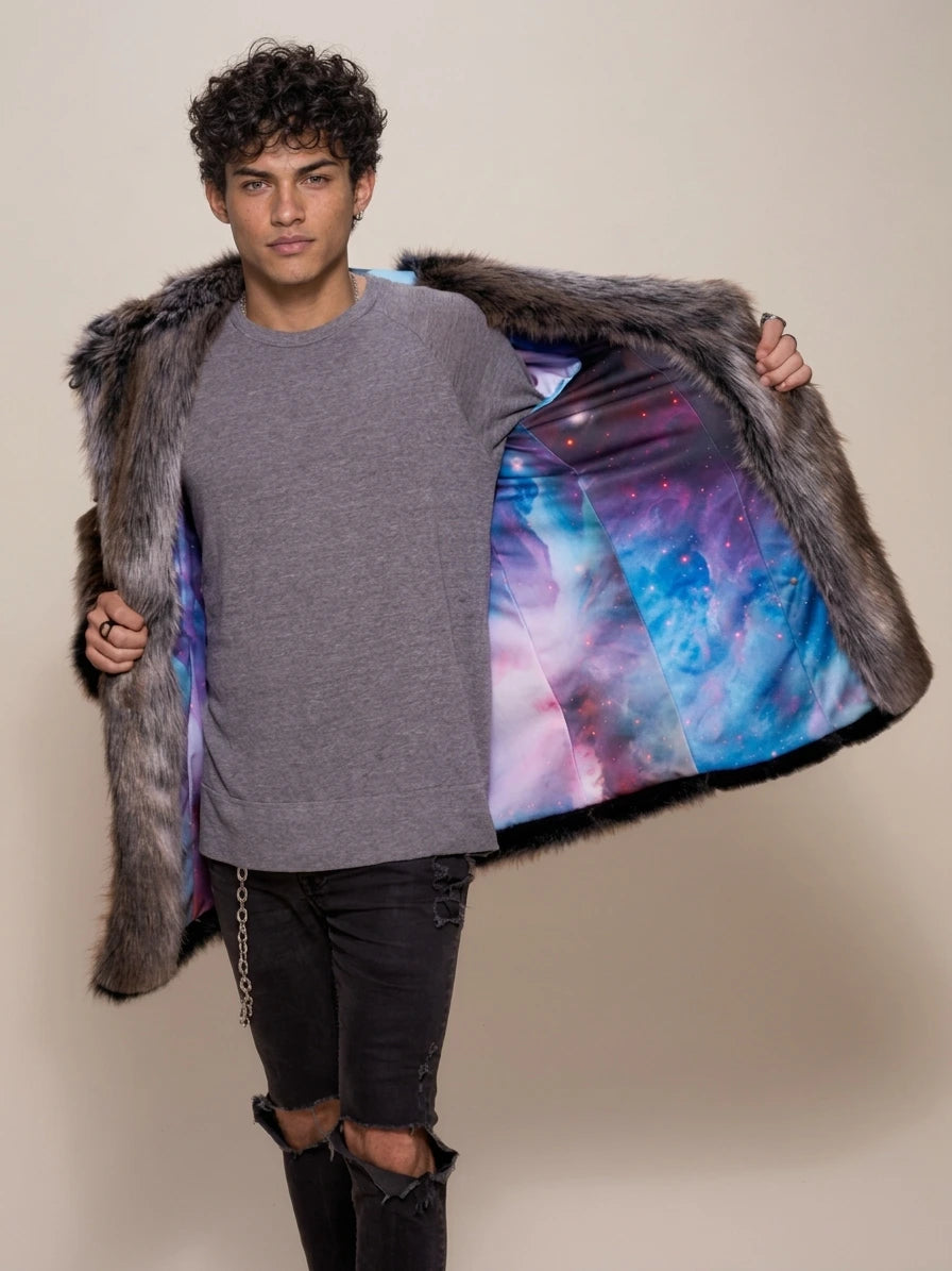 A man modeling a gray long-sleeve shirt and black ripped jeans, holding open a dark gray faux-fur trimmed coat that reveals a vibrant galaxy-print lining in shades of blue, purple, and pink.
