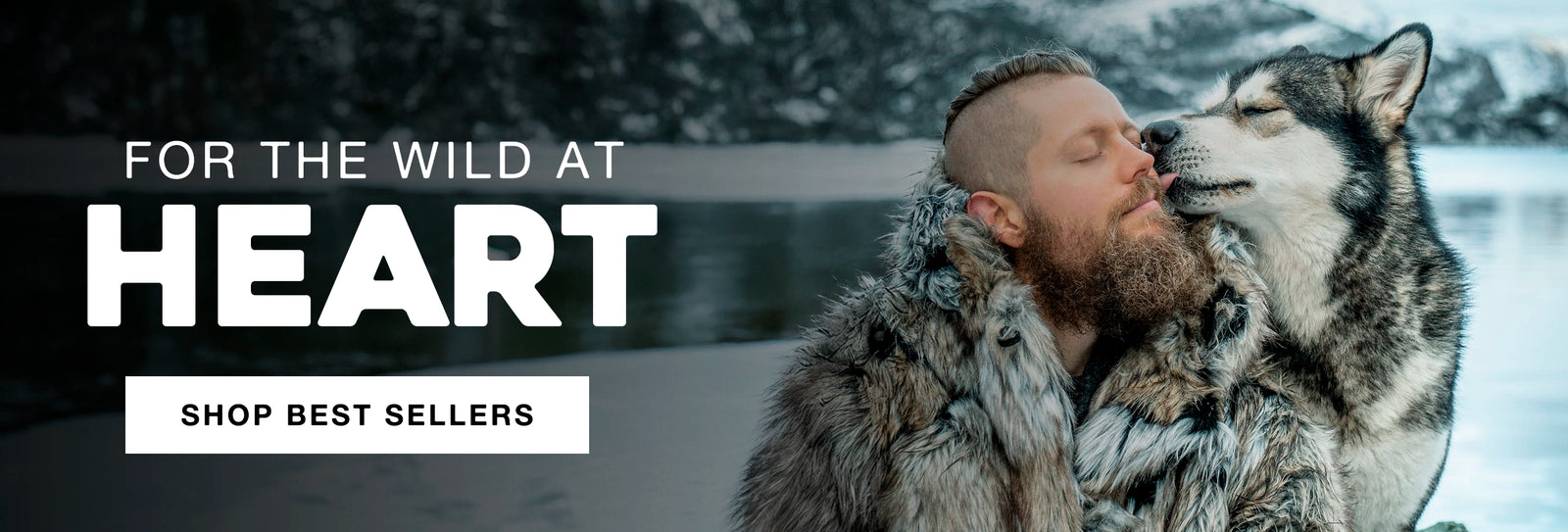 Man in fur coat with a dog in a snowy landscape, with text 'For the Wild at Heart' and 'Shop Best Sellers'.