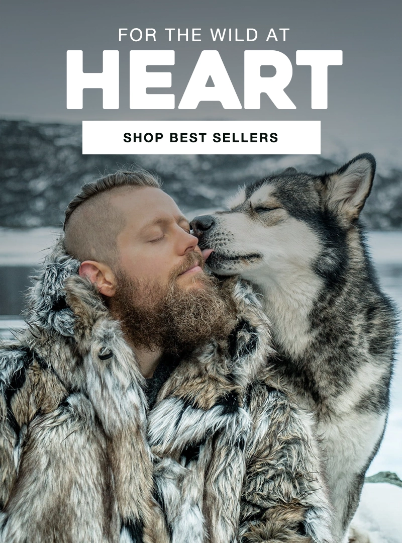 Man in fur coat embracing a wolf with text 'For the Wild at Heart' and 'Shop Best Sellers' on a snowy background.