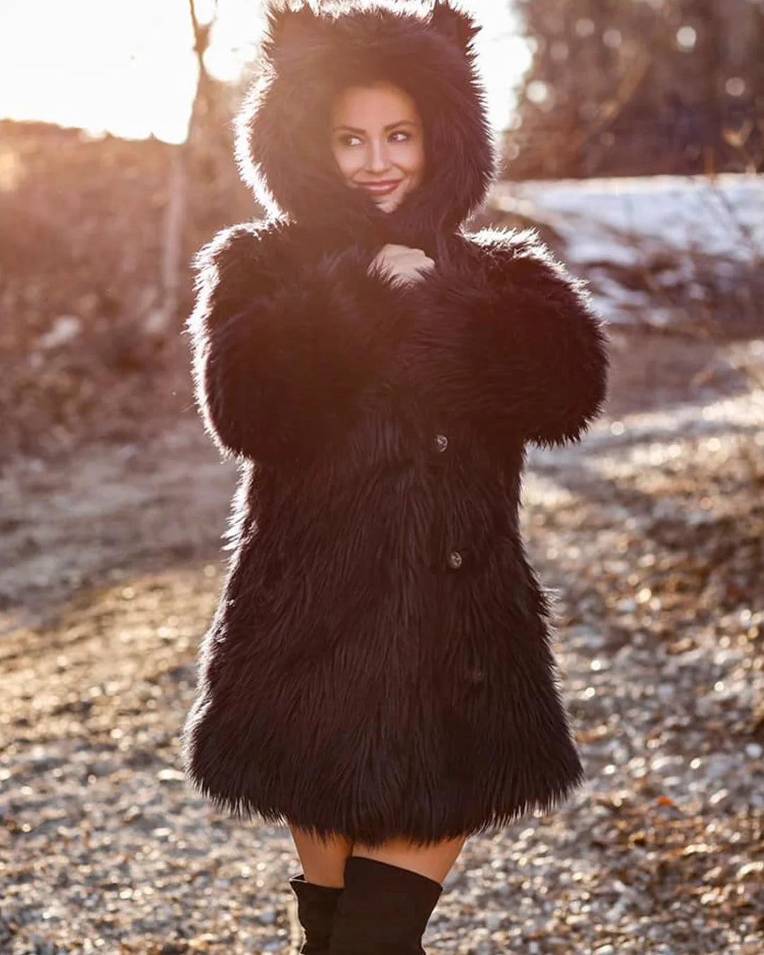 A Woman wearing a SpiritHoods all black faux fur coat in an ornate room with gold accents. SpiritHoods Best Selling Plush Long Pile Black Wolf inspired Fake Fur Jacket with an oversized hood and ears.
