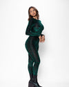 Side view of a curvy woman wearing a green tiger print full-body bodysuit with a white background.