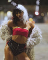 Person wearing a red top dressed as cruella deville, looking down, with her hands on her hips wearing SpiritHoods Long Baby Snow Leopard Faux Fur Coat. Easy Halloween Costume Party Outfit, Halloween Costumes
