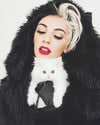 A women wearing SpiritHoods black wolf classic faux fur coat with the hood up, holding an all white kitty. Easy Halloween Costume Ideas for women 