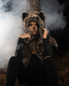 A Person with easy skull make up, sitting against a tree, in a forest at night, with smoke coming up behind her, wearing spirithoods best selling dire wolf fake fur shawl with wolf ears. Easy Halloween Outfits, Halloween Costumes.