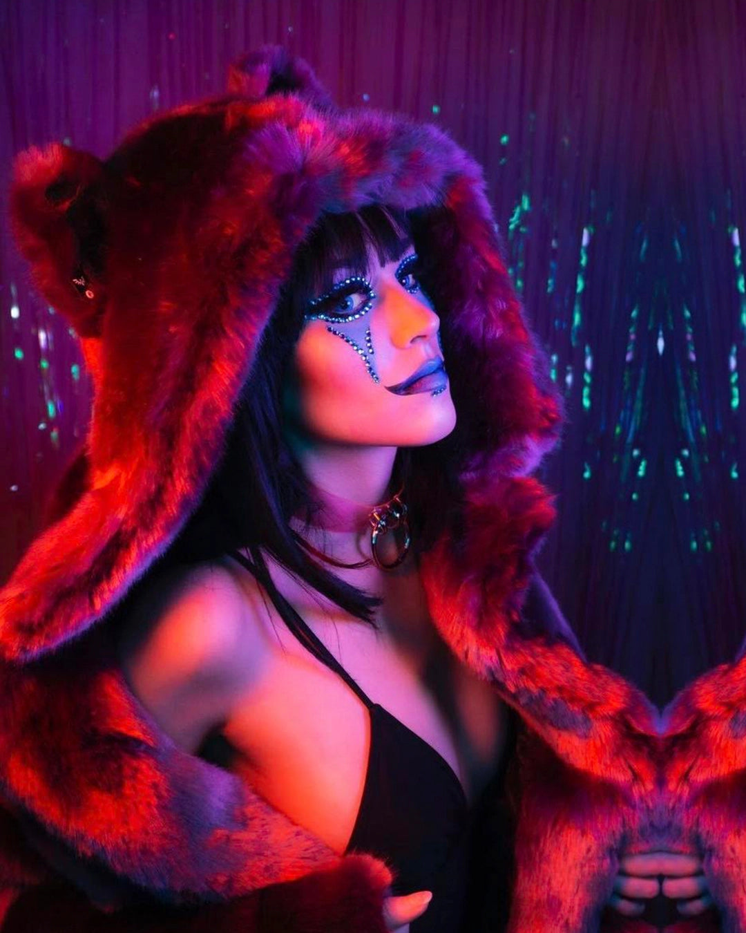 A Woman wearing SpiritHoods Luxe Classic Lavender Wolf Faux Fur Coat with one eye in david bowie inspired make up and sequins. Easy Halloween Make Up Ideas and Halloween Costumes for Women