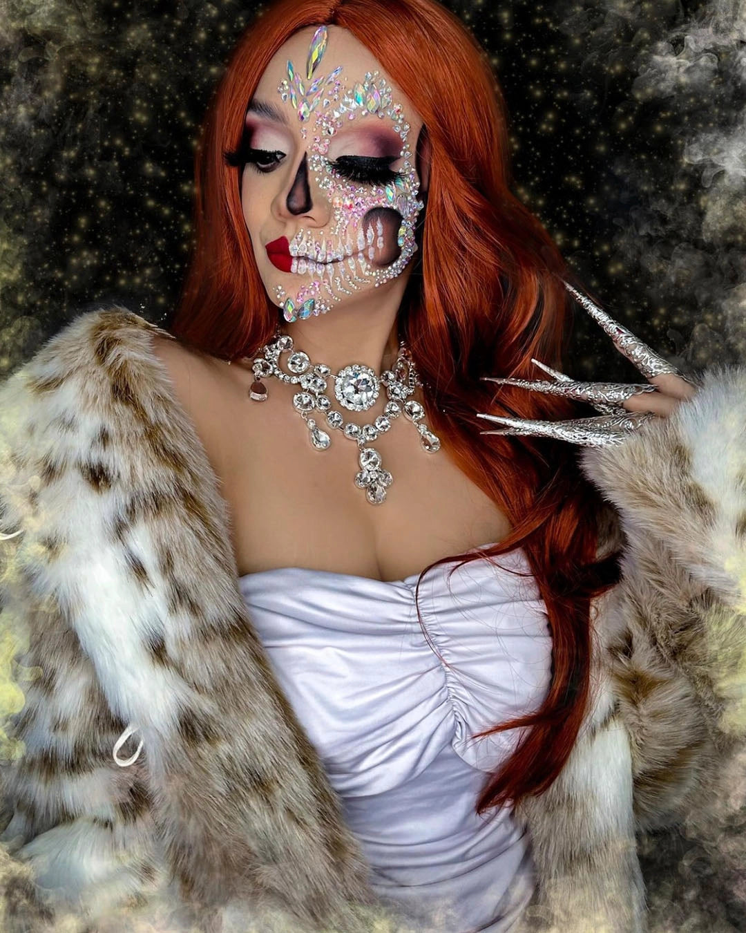 A Woman wearing SpiritHoods Siberian Snow Leopard Faux Fur Coat with sparkling rhinestone elaborate face makeup creating a white skull. Halloween Costume Ideas and Halloween Outfits.
