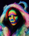 Woman wearing SpiritHoods Classic Rainbow Bear Faux Fur Coat with tiedye colors throughout, UV-blacklight reactive fake fur and face paint and bear nose. Halloween Costume Ideas. Halloween Make Up Inspiration.