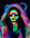 Person with colorful, UV-reactive makeup and UV-reactive SpiritHoods Rainbow Bear Fake Fur Coat against a dark background. Halloween Costume Ideas. Animal-themed costumes