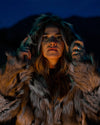 A Woman wearing a SpiritHoods Wolverine Hooded Fake Fur Jacket with the Hood up looking into the camera. Halloween Costume Ideas. Halloween Outfits for Women