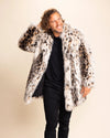 Man wearing a animal patterned fake fur coat over a black outfit against a beige background. SpiritHoods Custom Made Fall Winter Luxury Coats and Jackets in Plush Fake Fur.