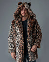 A Man wearing a leopard print fake fur jacket with hood and leopard inspired ears on a gray background. SpiritHoods Custom Made Fall Faux Fur Coats and Animal Print Jackets