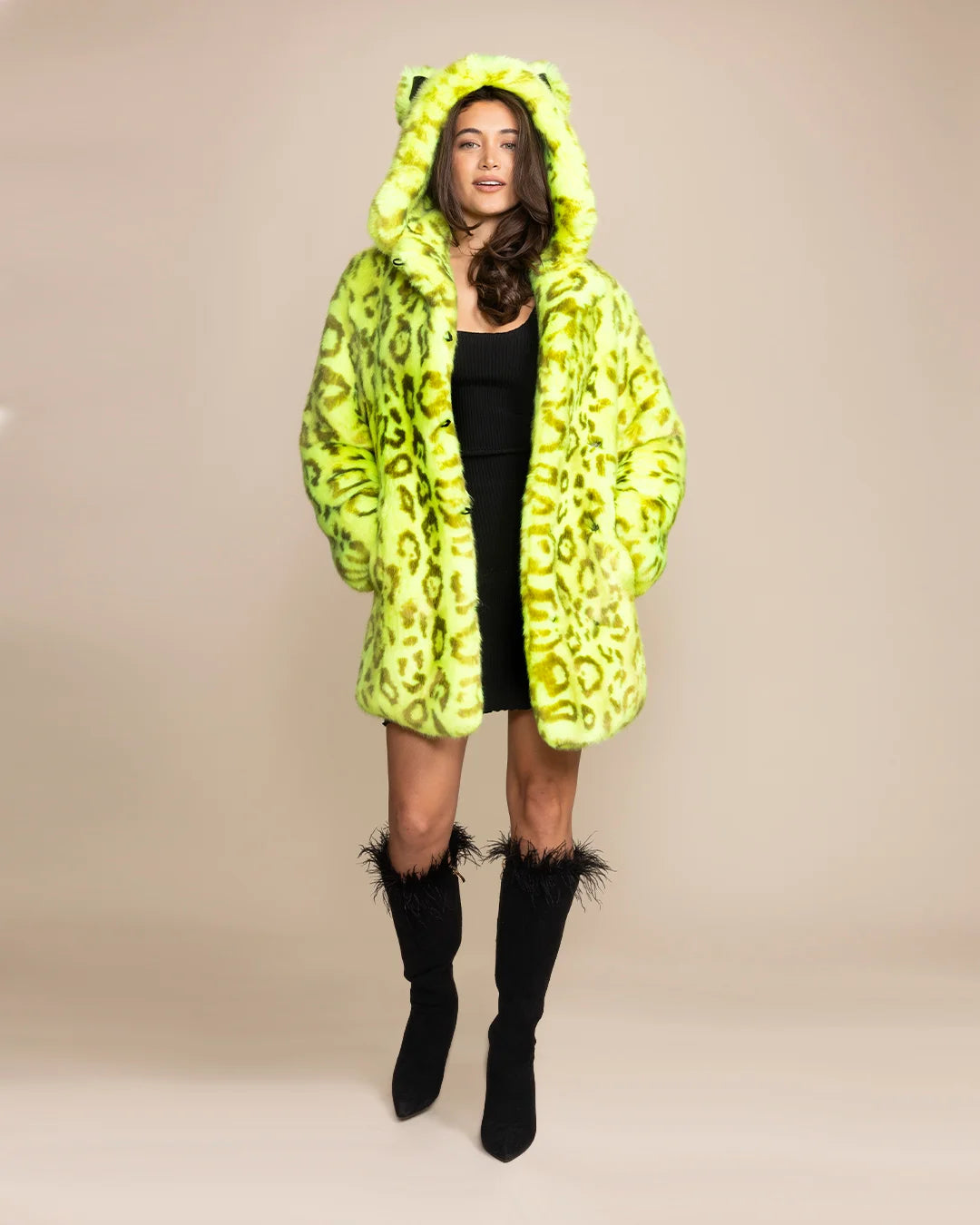 Woman wearing a Neon Yellow Leopard Luxury Faux Fur coat with an oversized hood and ears that glows under UV blacklight