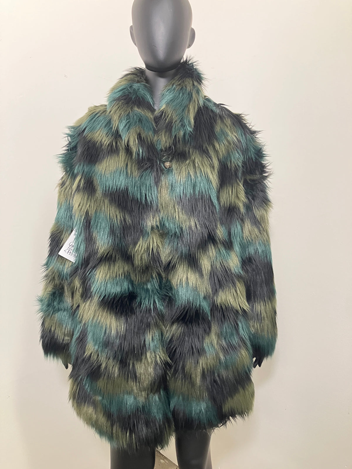 Faux Fur Multicolor green and brown coat with an oversized collar on a mannequin against a plain background