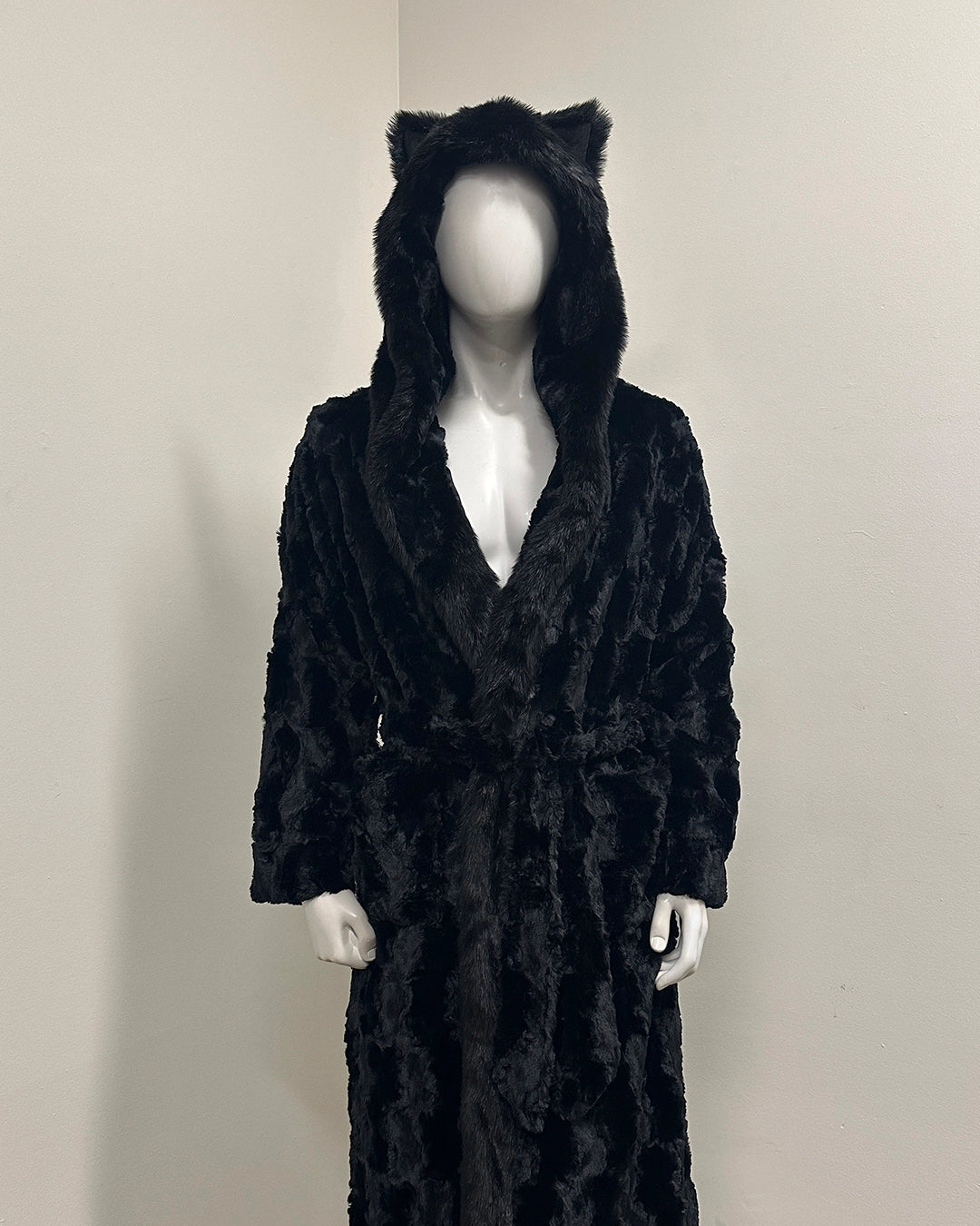Black plush robe with cat ears on a mannequin against a neutral background