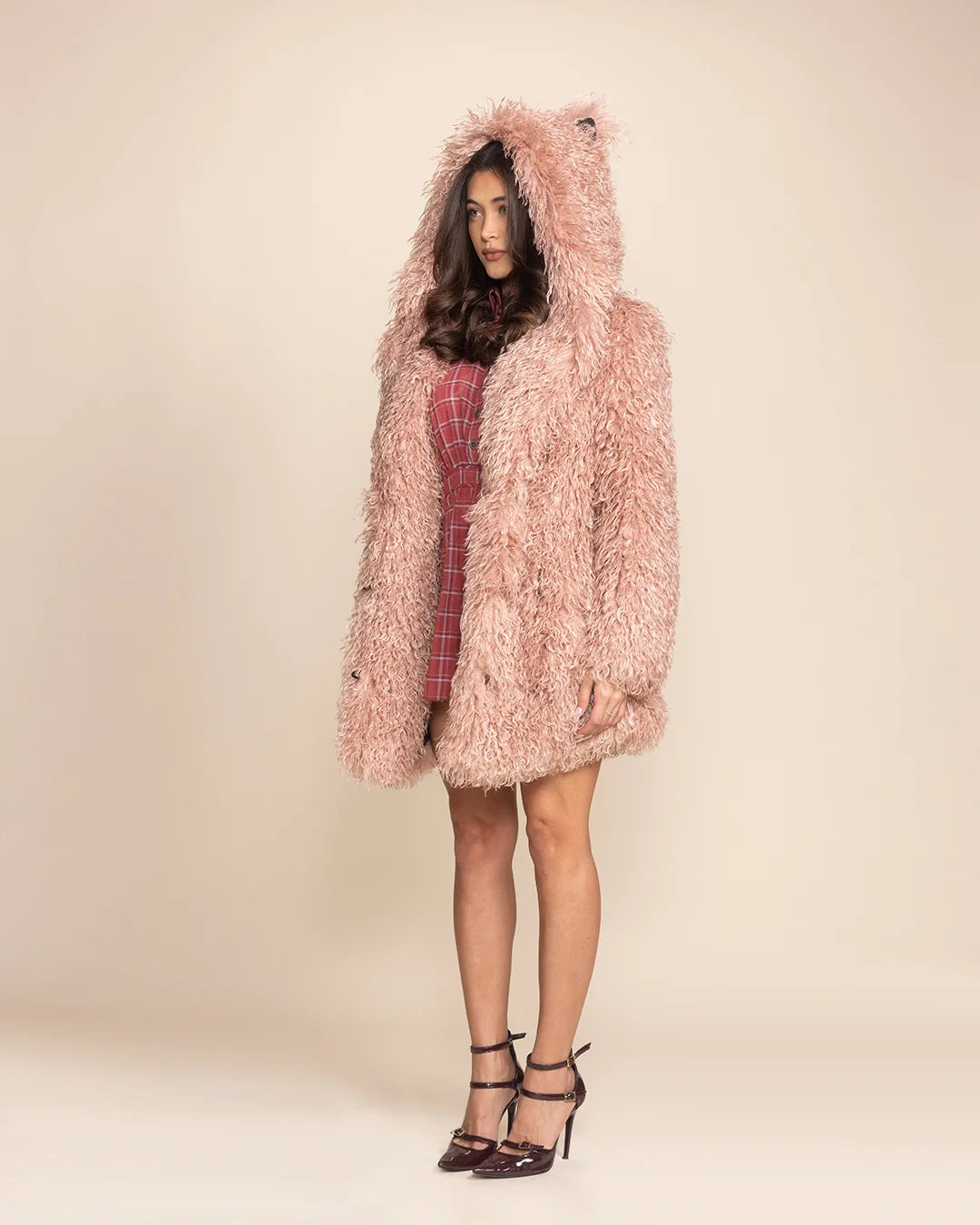 Bold date night look featuring a blush pink LaPerm Cat shaggy fur coat with four pockets and peacoat button closure.