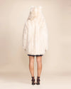 Animal-inspired vegan fashion: a plush ivory white wolf faux fur parka with signature ears and functional pockets