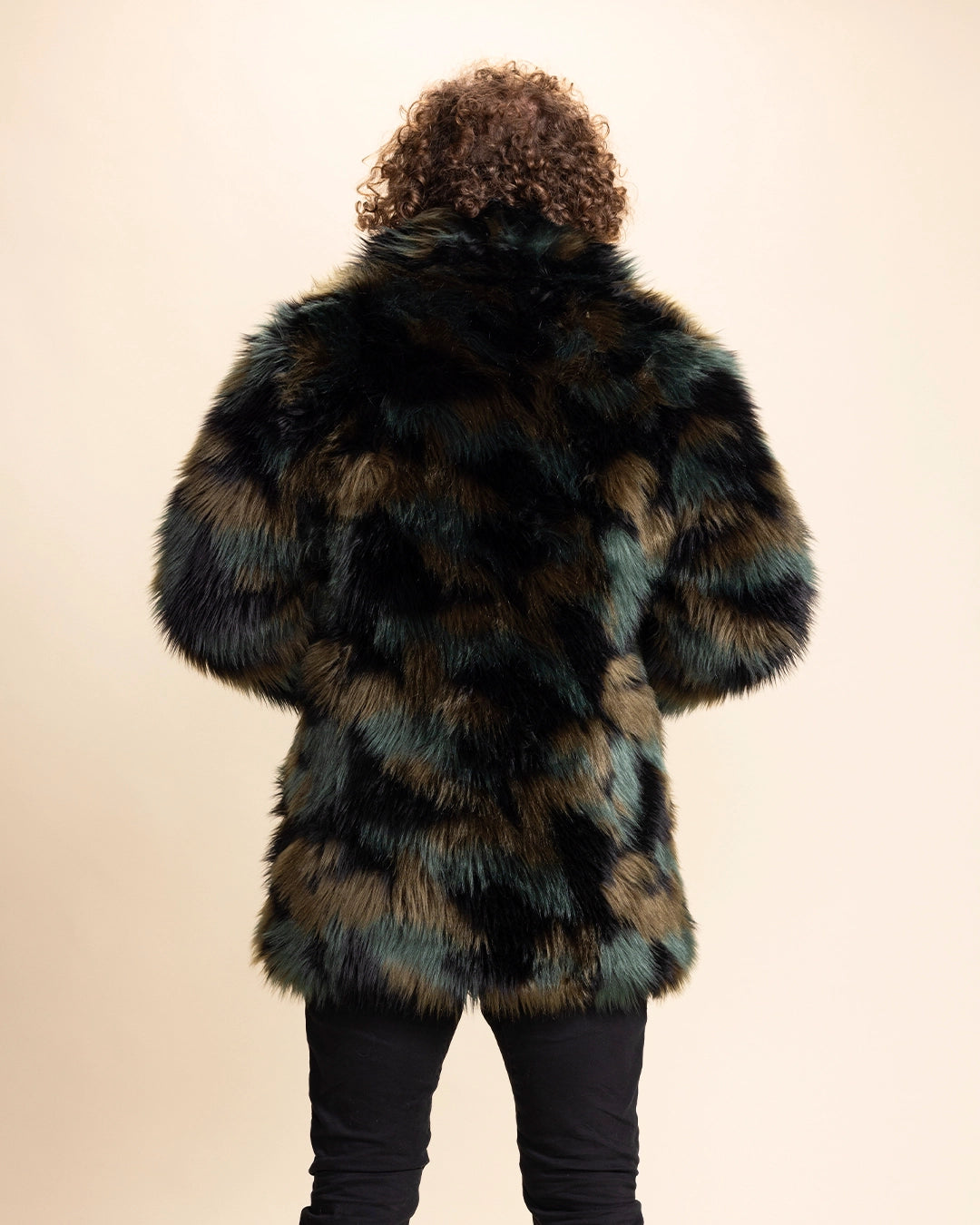 A Man facing away from the camera, wearing a SpiritHoods Custom Made Camo Cat Collared Fake Fur coat with a neutral background