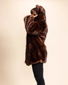 A Man wearing SpiritHoods Made to Order Classic Brown Wolf Faux Fur Coat facing away from the camera, as he pulls up the hood over his head. SpiritHoods Made to Order Luxury Fake Fur Coat - Fall Winter Custom Coat Collection