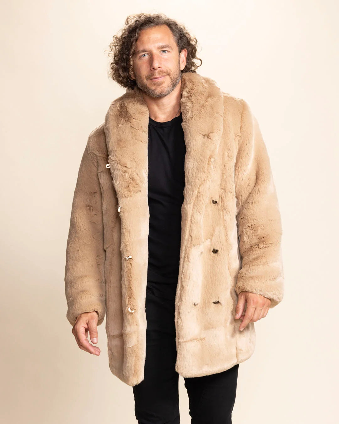 Man wearing a beige faux fur coat against a plain background. SpiritHoods Fall Winter Collection of Fake Fur Coats and Faux Fur Jackets for Men in Cougar