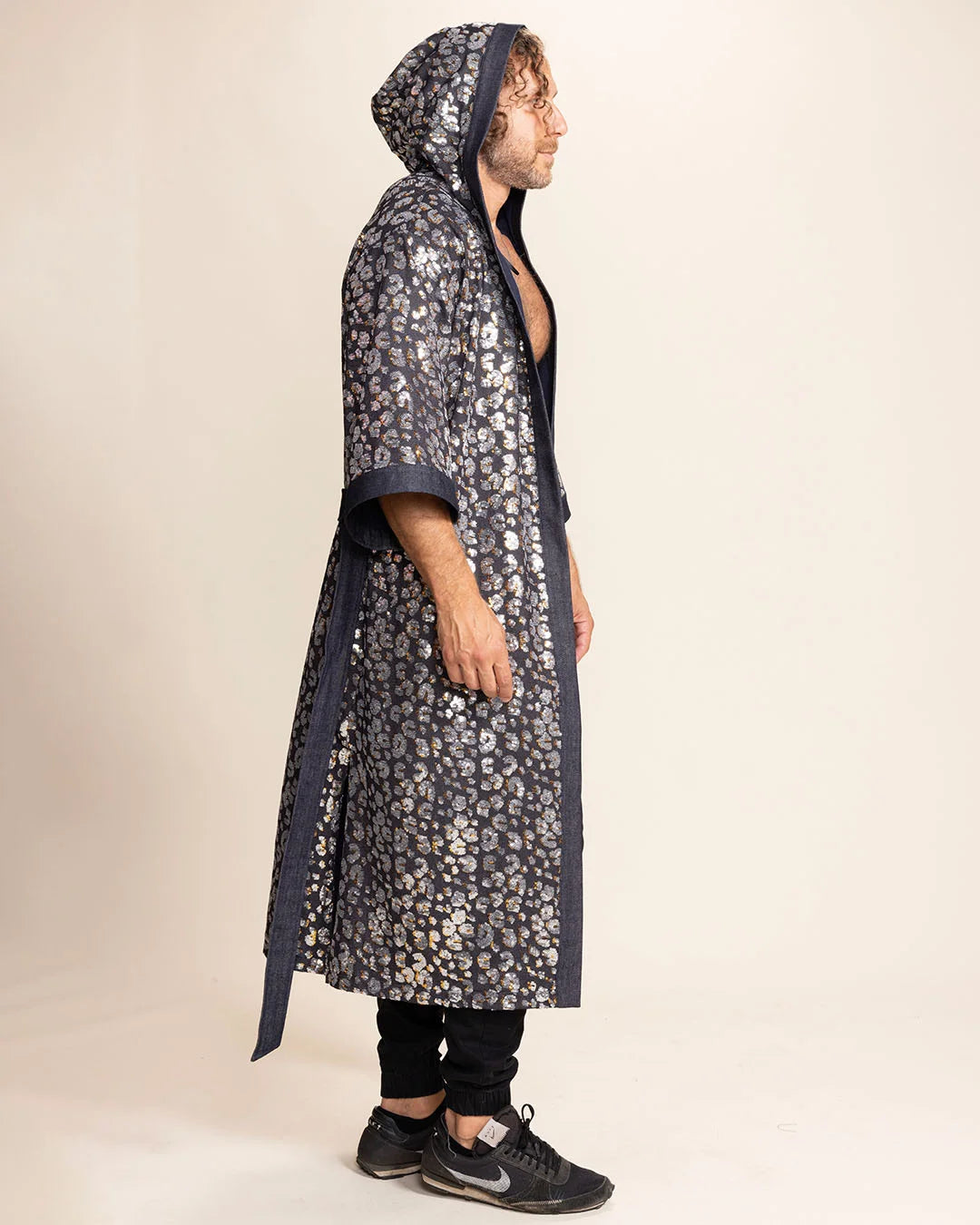 Person wearing a long Kimono with Silver Sequin Leopard Print on Denim with a hood, on beige background