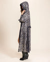 Women wearing a Denim Kimono with Hood and Belt-tie with shimmering silver and gold sequin leopard pattern on a beige background