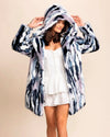 SpiritHoods Womens Model with her hands up looking down smiling, wearing the Limited Edition Hooded Blue Faux Fur Coat in Lucky Rabbit, with lavender and navy hues. Two Outer Pockets, Two Inner Pockets, Top Rated Womens Fake Fur Coats