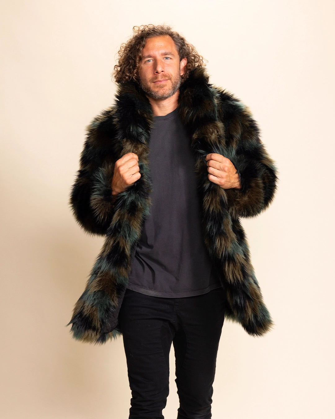 Man wearing a fur free green and brown coat against a beige background. SpiritHoods Custom Made Faux Fur Coats for Men ft the Camo Cat Collared Made To Order Jacket