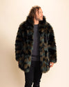 Man wearing a plush fake fur coat with greens and browns throughout, wearing the coat collar up, looking to the side smiling. SpiritHoods Fall Custom Coats and Fake Fur Jackets for Men.