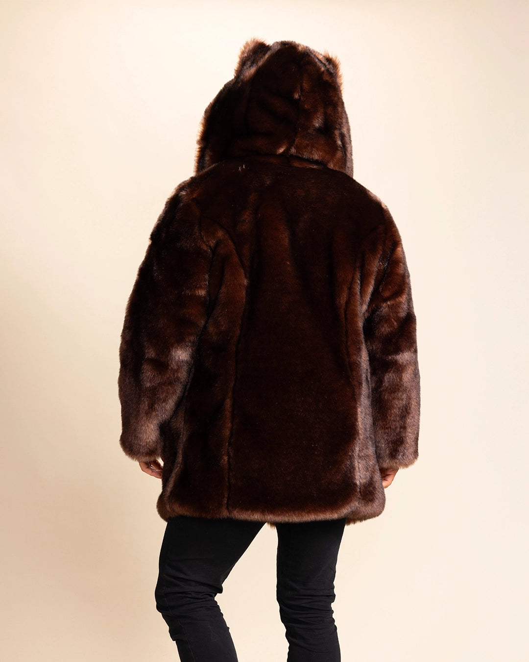 A man facing away from the camera, showing the back side of SpiritHoods plush Brown fake fur coat, with the hood up and wolf ears showing. Spirit Hoods Fall Winter Custom Made Coats and Fake Fur Jackets for Men