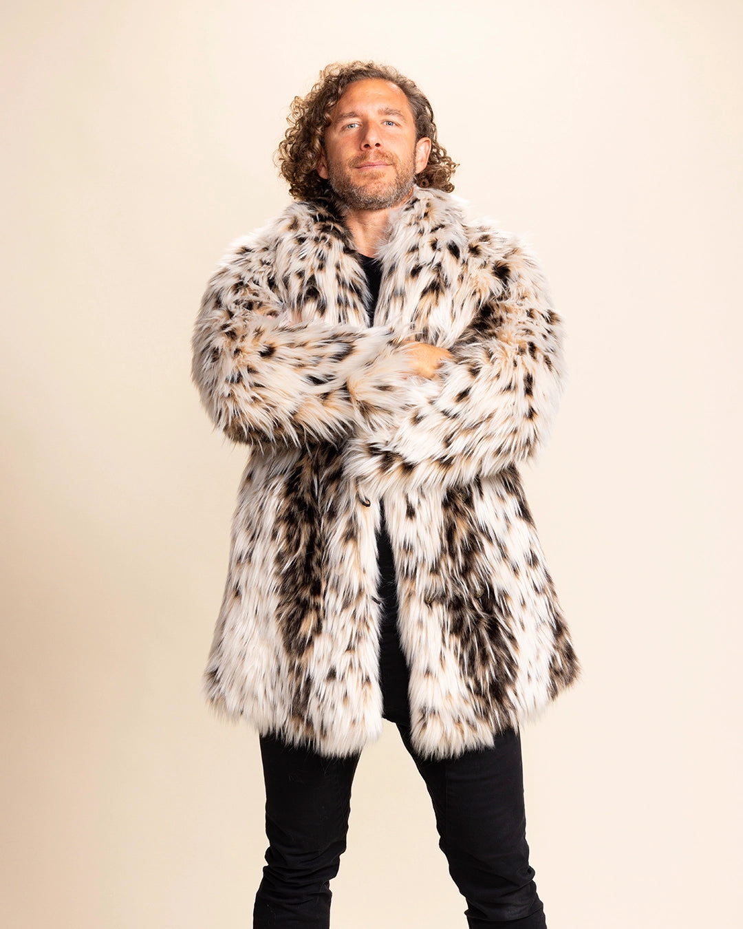 Man wearing a SpiritHoods Made to Order Cheetah Print Fake Fur Coat against a plain background. Custom fake fur jackets with animal face buttons, four pockets, and low-waste production