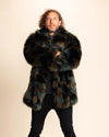 A man wearing a SpiritHoods Made to Order Custom faux fur coat in green and brown tie-dye style plush fake fur, against a beige background.