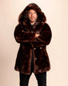 SpiritHoods Men's Hooded Faux Fur Coat in Brown Wolf. Vegan fake fur parka jacket for festivals, fall/winter layering. Model is facing the camera smiling with his arms folded infront of him, with the oversized hood up.