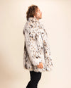 A Man wearing a cheetah print faux fur coat against a plain background. SpiritHoods Fall Winter Custom Made Fake Fur Jackets and Faux Fur Coats. Made to Order Cruelty-free Coats and Animal Print Layers.