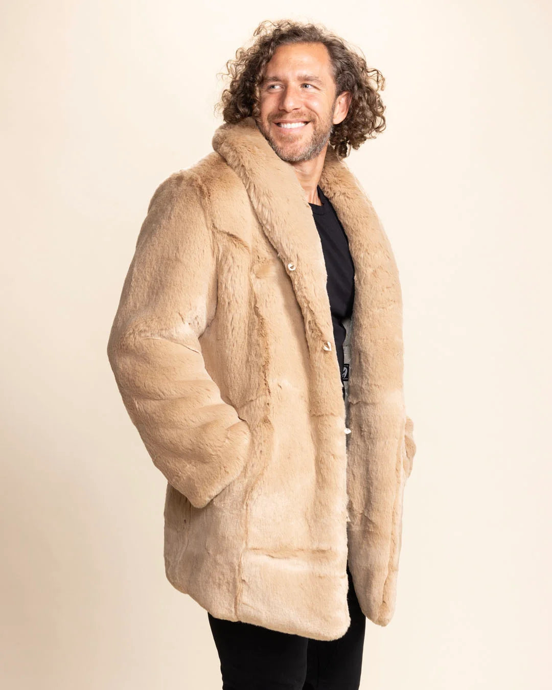 Man smiling, with his hand in the side pocket of SpiritHoods Cougar inspired brown faux fur coat with large oversized collar and peacoat button closure. PETA Approved Vegan Fashion Brand.