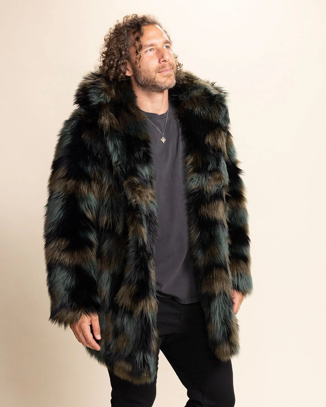 Man wearing a camo colored fake fur coat with a hood on a beige background