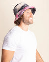 Person smiling wearing a colorful bucket hat against a plain background