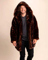 Man wearing a brown fake fur jacket on a beige background. Luxury festival-ready vegan faux fur coat.