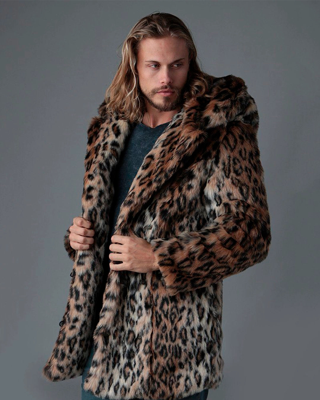 Man wearing a SpiritHoods best selling leopard print coat against a gray background. 100% Fake Fur Jackets Custom Made to Order - Limited Waste Faux Fur Coats and Animal Print Layers