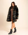 A woman wearing a SpiritHoods Collared multicolor green and brown faux fur coat with a neutral background. Made to order collared fur free coats for fall and winter.