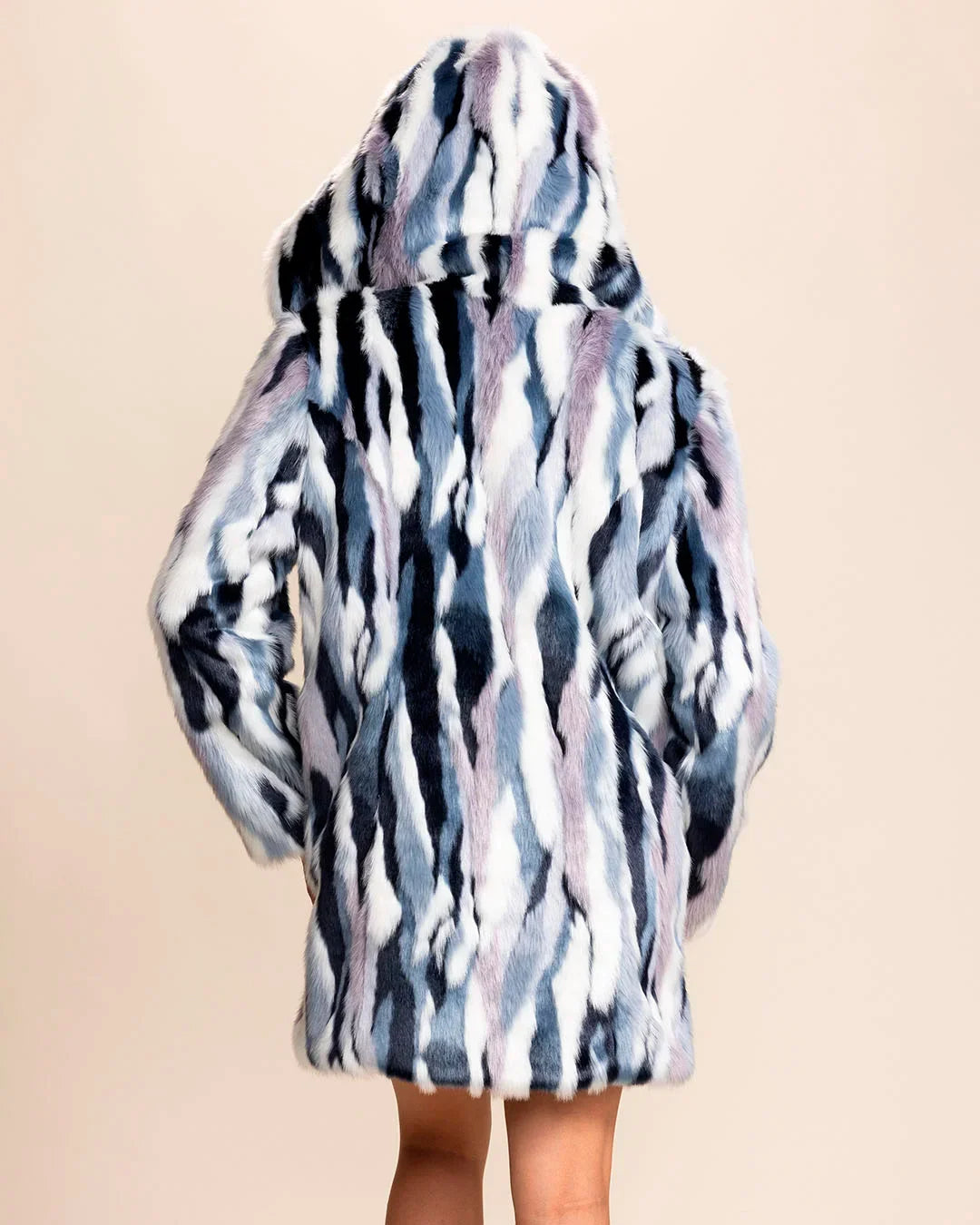 Back view of SpiritHoods Women's Hooded Faux Fur Coat in multicolor icy blue, lavender, purple, snow white, and midnight navy with oversized hood up and hands in the two outer pockets.