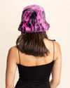 Person wearing a pink and black tiger stripe bucket hat on a beige background