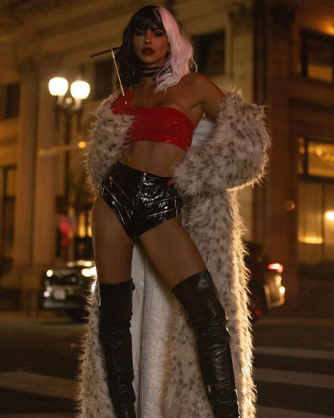 A Woman dressed as cruella deville wearing SpiritHoods Classic Baby Snow Leopard Long Fake Fur Jacket. Easy Halloween Costume Ideas. Halloween Outfits