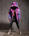 Person wearing a colorful neon leopard print faux fur coat with an oversized hood with ears, against a gray textured wall.