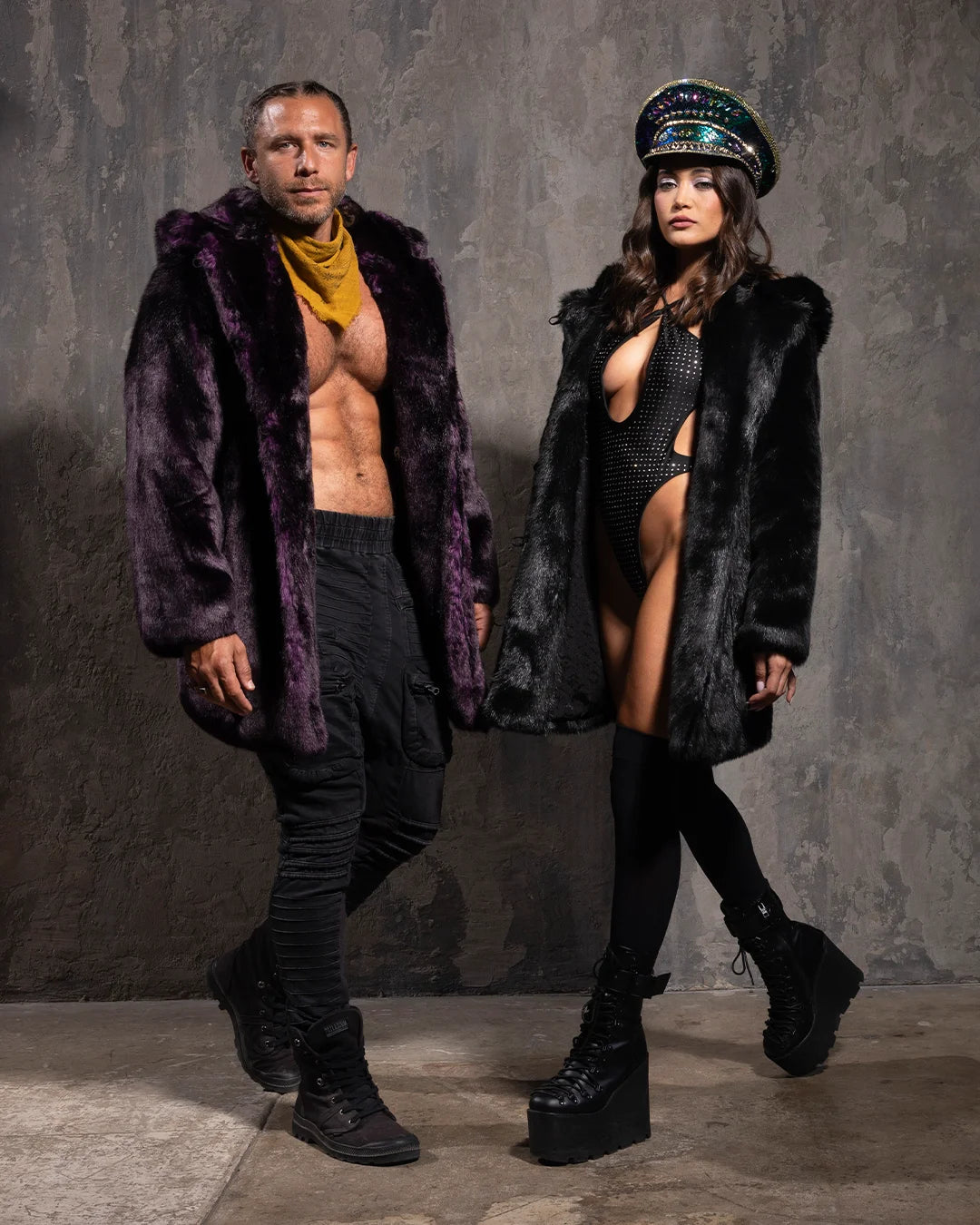 Male model looking down with arms out like an airplane,  wearing dark purple midnight wolf fake fur jacket with hood and ears. 