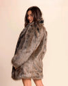 Woman wearing a Top-Rated Collared Fake Fur Coat in SpiritHoods best-selling Dire Wolf faux fur against a plain background